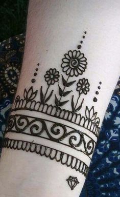 a woman's hand with henna tattoos on it