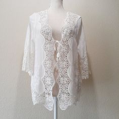 Creamy White Cotton Gauze With Embroidered Design Crochet Lace Trim All Around Crochet Cut-Out Design In Back Tassel End Ties In Front Note: This Item Is New With Tags But There Are No Interior Tags/Labels Such A Pretty Topper! Excellent Condition, New With Tags Size: "One Size" Approx." 21' Pit-To-Pit / 21' Across The Middle /24' Length Crochet Lace Blouse For Vacation, Vacation Crochet Lace Blouse, Spring Beach Cover-up Tops With Lace Trim, Embroidered Lace V-neck Top, Vacation Lace Tops With Lace Work, Fitted Lace Cover-up With Lace Trim, White Cotton Lace Crochet Top, White Crochet Lace Top For Brunch, Lace Trim Blouse For Beach