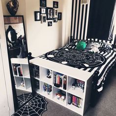 a bedroom with black and white decor on the walls, bookshelves and a bed