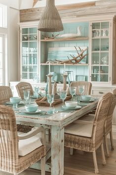 a dining room table with chairs and plates on top of it in front of a hutch