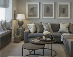 a living room filled with furniture and pictures on the wall