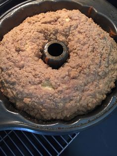 a bundt cake sitting on top of a pan in the oven, ready to be baked