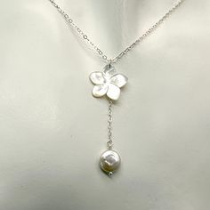 This necklace is a simple but elegant look with a lustrous carved white mother of pearl flower accented with a single iridescent freshwater coin pearl. There are beautiful tones of light pink and silver in the pearl and flower. The necklace is made with delicate sterling silver chain. It can be made in different lengths. The flower is approximately 5/8 inch in size. The chain and pearl hand down approximately 1 3/4 inches from the top of the flower to the bottom of the pearl. This length can be adjusted if needed with a message. There is a pair of matching earrings at the following link, https://www.etsy.com/listing/1381667541/white-mother-of-pearl-plumeria-earrings?click_key=0d0f10ba21be5d96335bc27968407565093661b0%3A1381667541&click_sum=ead1d502&ref=shop_home_active_1&clickFromShopCard=1 Beach Wedding Necklace, Coin Pearls, Dope Jewelry, Funky Jewelry, Jewelry Lookbook, Jewelry Inspo, Dream Jewelry, Piercing Jewelry, Pretty Jewellery