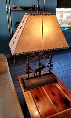 a lamp sitting on top of a wooden table next to a couch in a living room