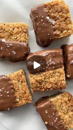 chocolate covered granola bars on top of white paper