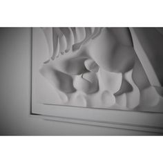 a black and white photo of an abstract art work on the wall in a room