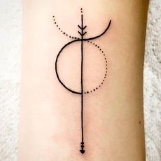 a small arrow tattoo on the ankle with dots and lines around it, as well as an arrow