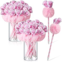 two vases filled with candy and pink lollipops on top of each other