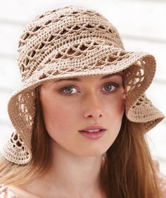 a woman wearing a brown crochet hat