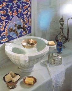 a white sink sitting under a mirror next to a faucet and soap dispenser