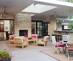 an outdoor living area with chairs and tables