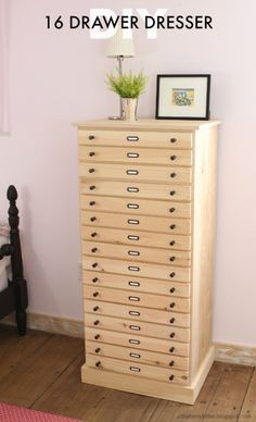 a tall wooden dresser with drawers in a pink room next to a lamp and bed