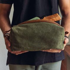 Canvas Dopp Kit for Men | Water-Resistant and Built to Last Perfect for travelers and everyday organizers, our Canvas Dopp Kit combines rugged durability with refined style. Crafted from water-resistant waxed canvas with leather accents, this versatile toiletry bag is designed for men who value functionality and style in their essentials. Available in Two Classic Colors: Choose from Olive or Brown  to match your style. ITEM DETAILS * Material: Durable waxed canvas with leather detailing for a rugged yet sophisticated look. * Size: Standard size, approximately 10" x 4" x 4" (L x H x W). * Features: One roomy main compartment, one secure zippered pocket, and two open pockets for easy organization. Soft cotton lining protects your essentials, while the lightweight design keeps it travel-frien Men’s Toiletry Bag, Rectangular Zipper Pouch Travel Accessories For Outdoor, Outdoor Travel Accessories: Rectangular Zipper Pouch, Practical Rectangular Pouch For Outdoor, Practical Rectangular Outdoor Pouch, Practical Rectangular Everyday Carry Pouch, Durable Green Bags For Everyday Use, Durable Green Everyday Bags, Mens Christmas Gifts