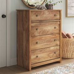 a wooden dresser sitting in front of a door with a mirror on top of it