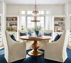 a dining room table with chairs around it