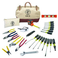 the tools are laid out on top of each other in front of a white bag