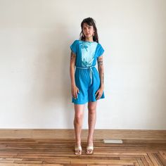 "This is a blue tropical romper from the late 70s early 80s. It features a contrasting light blue fabric at the bust, a waist tie, and a breezy material. \"Island Contrast\" label tag Fits XS-S Bust 30-33\" Waist 20-31\" Hip 45\" Length 36\" Cotton polyester blend Excellent condition" Blue Summer Jumpsuit With Elastic Waistband, Blue Summer Jumpsuits With Elastic Waistband, Blue Summer Jumpsuits And Rompers With Elastic Waistband, Blue Relaxed Fit Jumpsuits And Rompers For Beach, Blue Jumpsuits And Rompers With Elastic Waistband For Vacation, Blue Jumpsuit With Elastic Waistband For Vacation, Light Blue Cotton Summer Jumpsuits And Rompers, Light Blue Cotton Summer Jumpsuit, Light Blue Cotton Jumpsuits And Rompers For Summer