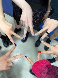 a group of people standing in a circle with their hands on each other's fingers