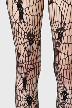 ARDINEA.- Soft, stretch fishnet.- Statement web style net with interwoven skulls.- Elasticated waistband.- Footless.- Fitted.With KIHILIST branding, 94% Polyamide, 6% Elastane. Hand wash cold (30°c) / Do not bleach / Do not tumble dry / Iron at low temperature / Do not dry clean. Imported. Black Stretch Punk Hosiery, Edgy Stretch Mesh Tights, Black Stretch Alternative Hosiery, Halloween Stretch Emo Bottoms, Edgy Stretch Fishnet Tights, Black Fishnet Bottoms, Stretch Hosiery For Halloween Party, Black Gothic Fishnet Hosiery, Gothic Black Fishnet Hosiery