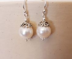 To Enter My Shop https://OccasionsGiftShop.etsy.com DESCRIPTION These beautiful freshwater pearl and silver earrings are sooo versatile; They're fancy enough for a wedding, or would be great for everyday! ~ Sterling Silver ear wires and bead cap ~AAA Grade 10-11 mm freshwater pearls Handmade Silver Earrings For Bridesmaid Gift, Elegant White Earrings For Birthdays, Elegant White Earrings For Birthday, Handmade Teardrop Bridal Earrings As Gift, Handmade Adjustable Pearl Earrings For Gifts, Nickel-free Earrings For Wedding On Mother's Day, Nickel-free Pearl Earrings For Gift, Nickel-free Silver Pearl Earrings For Party, Nickel-free Pearl White Sterling Silver Earrings