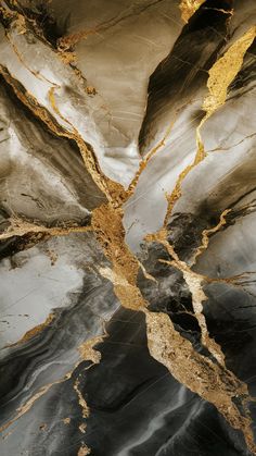 an abstract marble pattern with gold and black colors in the center, as seen from above