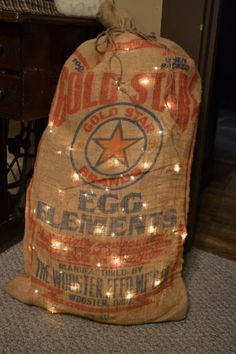 an old bag with lights on it sitting on the floor in front of a table