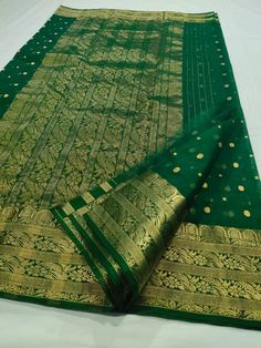 This Pure Chanderi Katan Silk Original in dark green with Single naal thousand buttis and a grand border and Aanchal is an absolute masterpiece. This is an authentic saree handwoven in the same weaving technique and style with which Anushka's beautiful saree was made. The Material, design, and quality are exactly the same as the one that Anushka wore to one of the most prestigious award ceremonies. The grandeur of this Saree makes it a perfect pick for ANY occasion. To see our entire Chanderi co Traditional Dark Green Dupatta With Cutdana, Dark Green Traditional Wear With Cutdana, Green Ceremonial Saree For Diwali, Dark Green Dupatta For Wedding And Festivals, Green Ceremonial Saree For Festive Occasions, Festive Green Ceremonial Saree, Dark Green Wedding Dupatta For Festivals, Green Anarkali With Traditional Patterns, Dark Green Saree With Zari Work