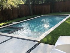 an empty swimming pool in the middle of a backyard