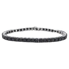 The item in question is a luxurious bracelet adorned with 44 black diamonds, boasting a total weight of 16.50 carats. The diamonds are cut in the brilliant style, which enhances their sparkle and light reflection. The color of the diamonds is a rich black, with an opaque appearance that has been enhanced to achieve a deeper shine. The quality of the cut is regarded as very nice, suggesting that the diamonds have been skillfully shaped to maximize their brilliance. The bracelet is crafted from 14 karat gold, with a hallmark confirming its authenticity. It has a total weight of 17.5 grams, indicating a substantial but comfortable piece. The bracelet measures 18.5 cm in length, making it suitable for most wrist sizes. This item is in new condition, with no visible signs of wear, and the quali Elegant Black Diamond Round Bracelets, Elegant Black Diamond Round Bracelet, Elegant Bracelet With Black Diamonds, Fine Black Jewelry Bracelet, Classic Round Black Diamond Bracelet, Luxury Black Diamond Bracelet With Round Shape, Black Diamond Round Bracelet, Classic Tennis Bracelet With Black Diamonds, Formal Tennis Bracelet With Black Diamonds