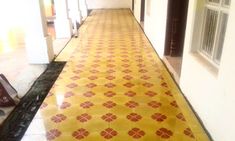 a hallway with yellow and red tiles on the floor