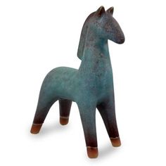 a blue horse figurine sitting on top of a white surface