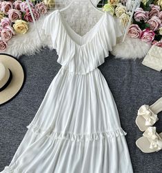 White v neck fringed dress A line fashion dress Fabric: blended Color: white Size(cm): S, M, L S length 100 bust 92-93 M length 101 bust 96-97 L length 102 bust 100-101 White A-line Maxi Dress With Ruffles, White V-neck Maxi Dress For Summer, Elegant White V-neck Dress With Ruffles, White V-neck Midi Dress For Vacation, White V-neck Maxi Dress, White Maxi-length V-neck Beach Dress, Elegant White Dress With Fringe, White Maxi V-neck Dress For Beach, White A-line Midi Dress With Ruffles