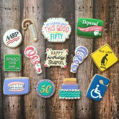 decorated cookies are arranged on a wooden surface