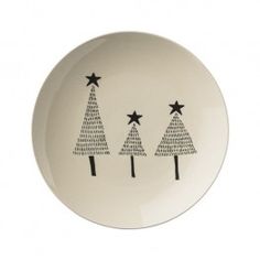 three christmas trees on a white plate with black stars in the shape of small trees