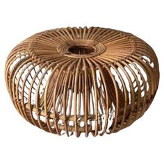 a round wicker stool made out of wood and rattan, on a white background