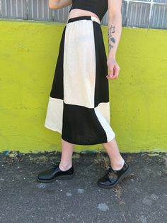 A black and white quilted mid length skirt with an elastic waistband * Hand sewn * 100% Linen Cotton * Elastic Waistband * Printed with high-quality eco-friendly ink Want the skirt shorter? We offer custom lengths at no additional cost. If you decide to go this route please email us after your purchase with your order number and we'll add it to your order note. Although please keep in mind that due to the weight of the fabric, mini skirt lengths are not advised. The model is 5'9 and wearing size Black Patchwork Tiered Skirt, Black Tiered Patchwork Skirt, White Midi Bottoms With Elastic Waistband, White Midi Length Bottoms With Elastic Waistband, Retro Black Long Skirt, Black And White Quilts, Skirt Linen, Mid Length Skirt, Quilted Skirt