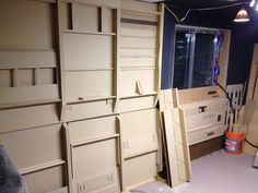 there are many cabinets in the room and one is being worked on with it's doors open