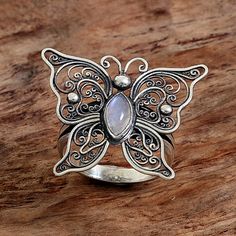 A butterfly with open wings rests atop this cocktail ring with a single rainbow moonstone on its body. Handcrafted with intricate Balinese swirl motifs in sterling silver this piece features designs by Indonesian artisan Eka Devi. Filigree Jewellery, Butterfly Cocktail, Open Wings, Butterfly Ring, Butterfly Jewelry, Birthday Jewelry Gift, Filigree Ring, Girls Jewelry, Butterfly Design