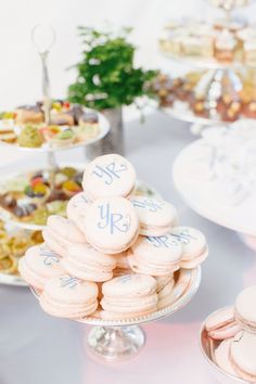 a table topped with lots of desserts covered in frosted cookies and pastries