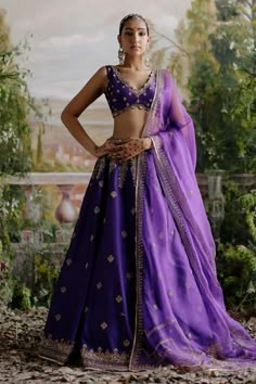 Orchid purple attached cancan lehenga with floral dori, aari embroidery. Paired with embroidered padded blouse and embroidered dupatta.
Components: 3
Pattern: Embroidered
Type Of Work: Floral
Neckline: V neck
Sleeve Type: Sleeveless
Fabric: Chanderi, Organza, Lining: Shantoon
Color: Purple
Other Details: 
Back tie-up detailing
Scallop border
Approx. product weight: 7-8 kgs
Note: The outfit worn by the model on left is not for sale
Occasion: Wedding - Aza Fashions Purple Indian Outfit, Modern Lehenga Designs, Lehenga Purple, Modern Lehenga, Eye Embroidery, Purple Lehenga, Blouse Lehenga, Lehenga Pattern, Raw Silk Lehenga