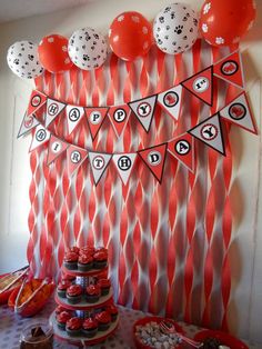 an orange and white dessert table with balloons