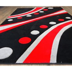 a black rug with red and white circles on it