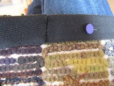 a close up of a person wearing a belt with buttons on the back of it