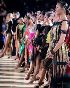 a group of women standing next to each other on a runway