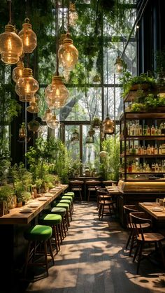 the inside of a restaurant with lots of plants and lights hanging from it's ceiling