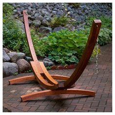 a wooden bench sitting on top of a brick walkway