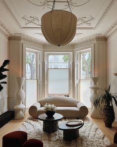 a living room filled with furniture and large windows