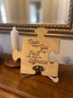 a wooden puzzle piece that says never you forget the peace and try to make the difference