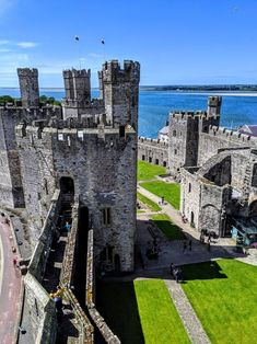 an aerial view of the castle and its surrounding grounds, with people walking around it