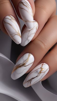 An opulent and artistic design inspired by natural stone. All nails feature a white marble effect with fine golden veining running across each nail, creating a luxurious and sophisticated statement look. Ideal for #MarbleNails, #GoldenNailArt, #LuxuryNails, #2025NailTrends, and #ElegantNailDesigns. Beige And White Nails, White And Gold Marble Nails, Golden Nail Art, All Nails, Engagement Nails, Dream Things, Elegant Nail, Graduation Nails, Elegant Nail Art